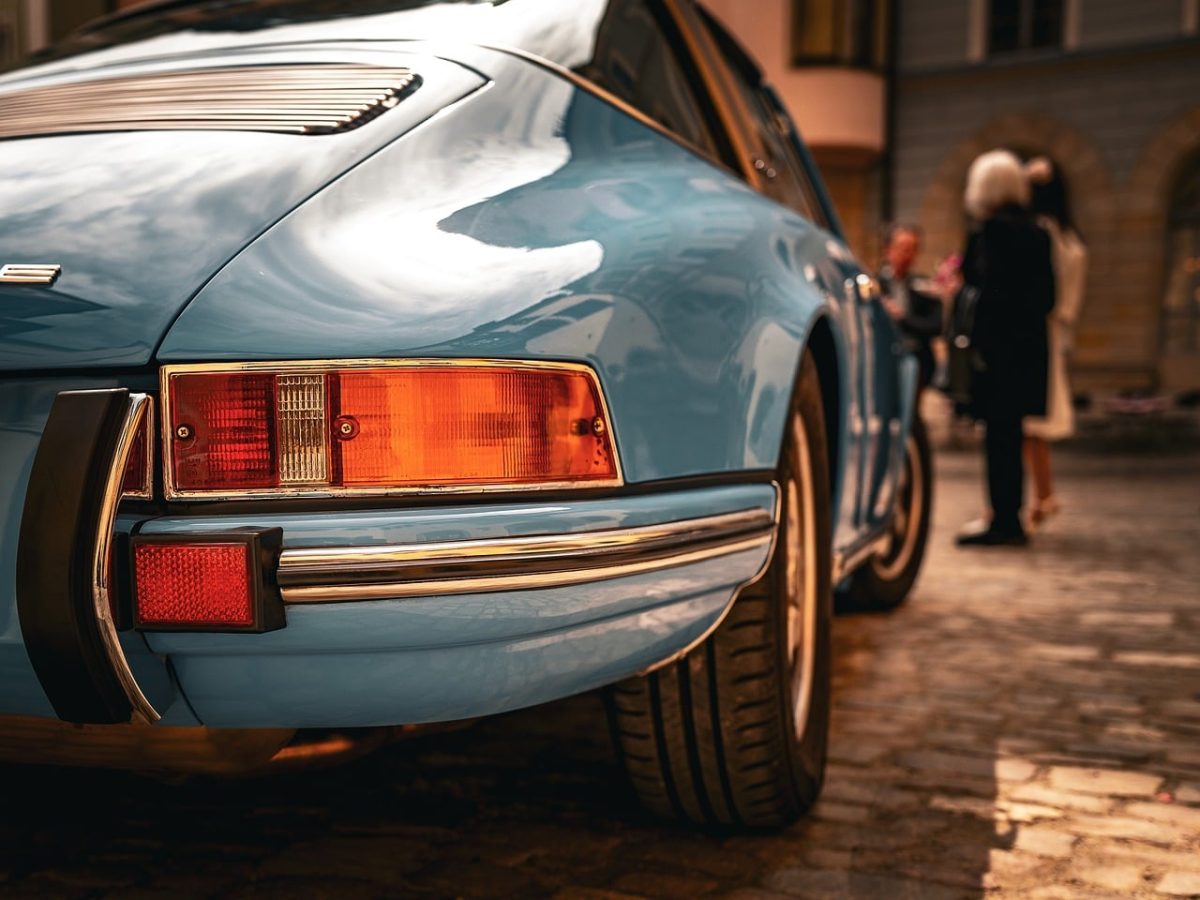 sports car, luxury car, classic car, retro design, blue car, convertible, exhaust, wheels, antique, collector car, taillights, expensive, rubber tires, paint, vintage, brand, asphalt road, outdoors, city, focus on car