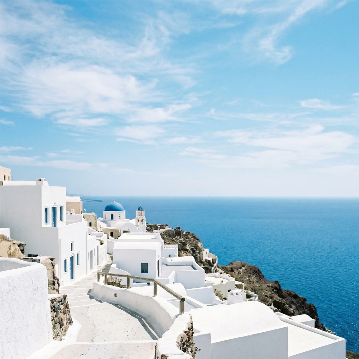 white houses, blue domes, ocean, coastal, travel, architecture, scenic, coastline, village, tourism, island, greece, cyclades, blue sky, aerial view, mediterranean sea, tourist attraction, white stucco, santorini, nature, seaside village