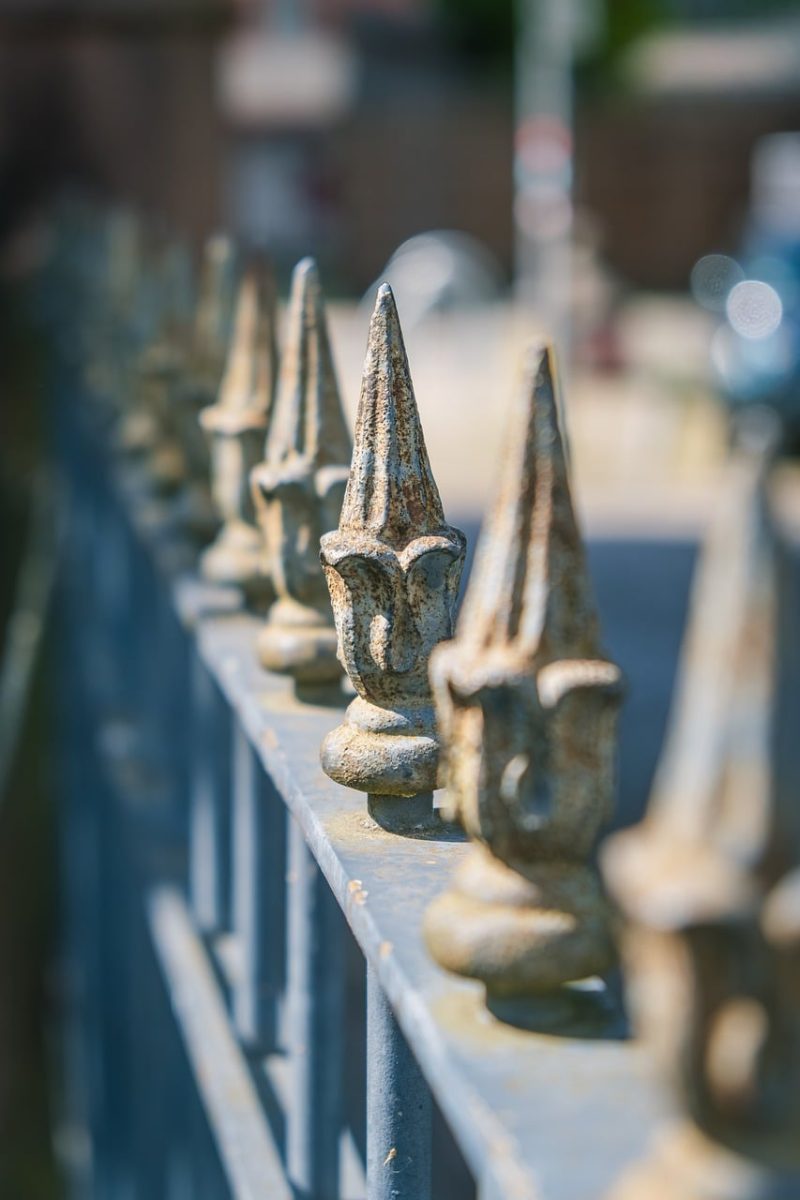 metal fence, rust, metal, foreground focus, sunlight, pointed, depth of field, artistic photography, bokeh effect, details, focus, focus width, daylight photography, detail focus, line, sharp, architectural element, symmetry, outdoor scene, metal art