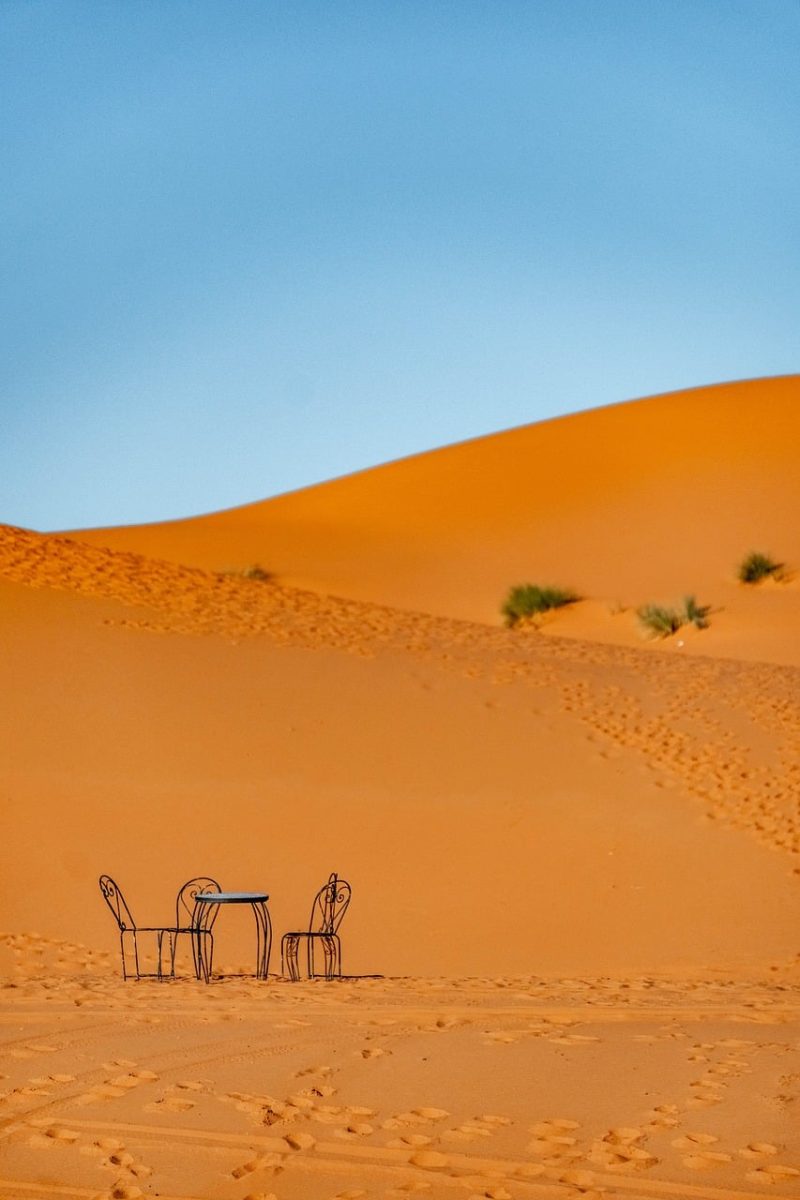 desert, dune, table set, blue sky, chair, morocco, dining, sand, nature, sunlight, warm, hiking, adventure, vacation, outdoor, tranquility, relaxation, natural scenery, rest, comfort, view