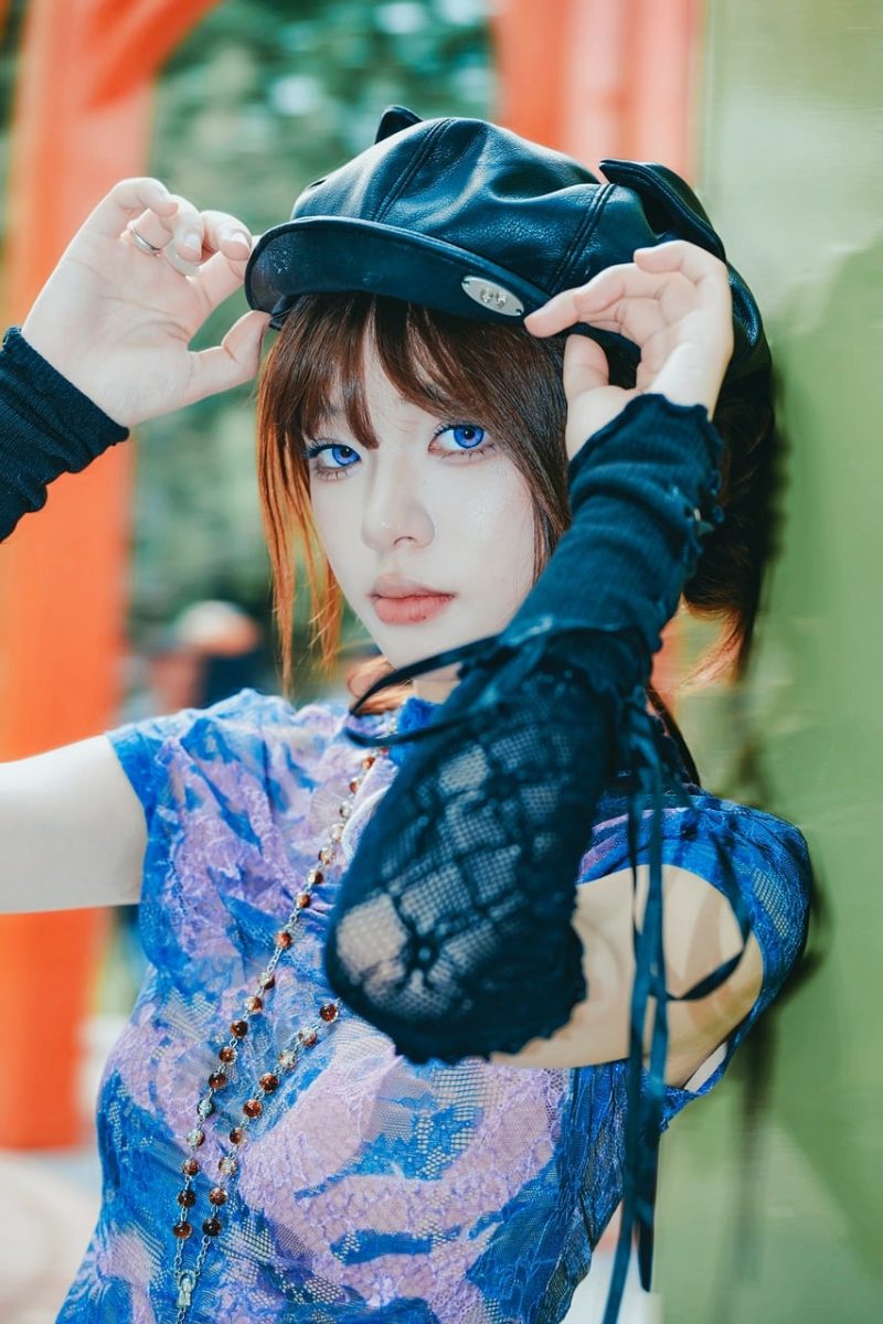 young woman, blue eyes, leather cap, girl fashion, fair skin, fashion accessory, orange column, blue dress, necklace, black gloves, fashion, outdoors, trend, style, portrait, fashion photography, urban girl, creative, youthful, stylish, posing