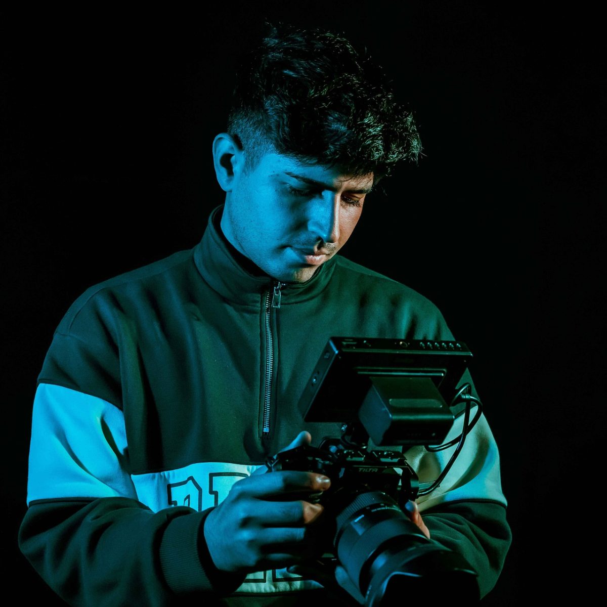 cameraman, camera, professional, lighting, dark background, video production, film, focus, engagement, man, creativity, young adult, portrait, male, hobby, culture, wardrobe, film history, editing