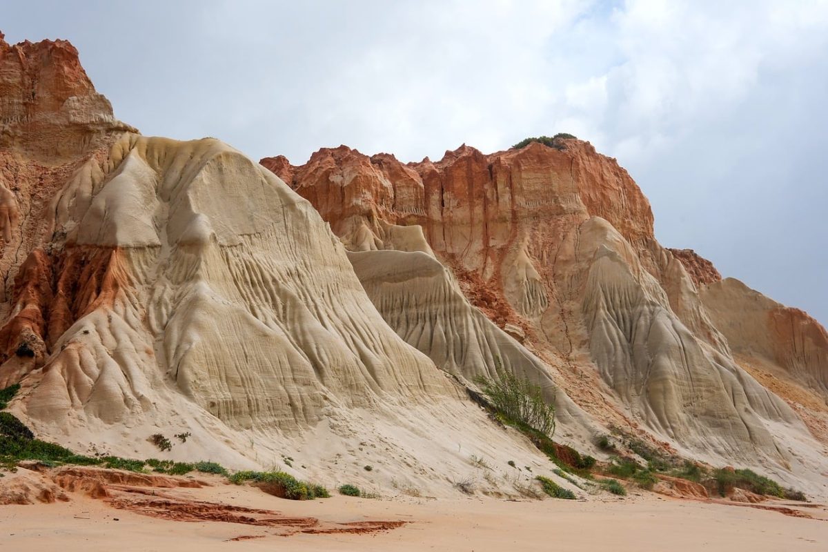 coast, cliffs, natural beauty, sandy beach, geology, clouds, orange rock, tourism, wilderness, coastal landscape, natural formation, eroded, nature, beach cliffs, blue sky, summer day, calm, natural monument, nature world, view, serene environment