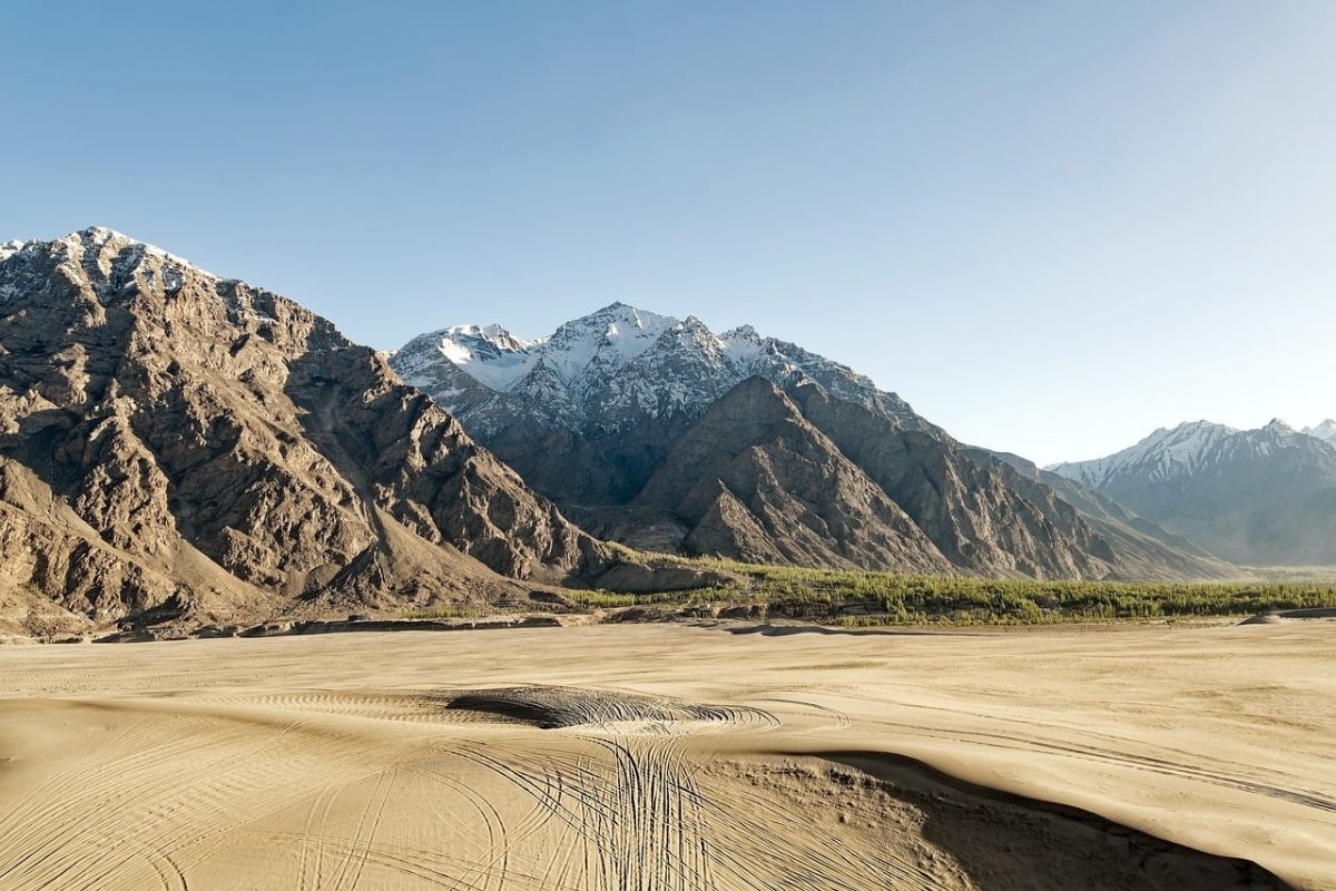 mountains, sand desert, snowcapped peaks, valley, blue sky, desert, mountain foothills, trees, view, natural landscape, landscape, sun, dry, shadows, summer, sunny, sky, sand, natural beauty, travel destination, tranquility