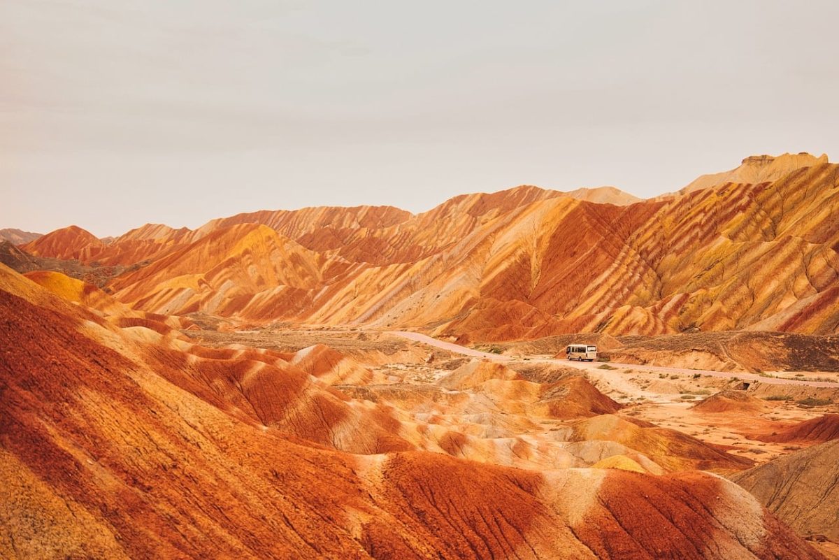 colorful mountains, chinese geological park, danxia landscape, desert scene, mountain landscape, rock formations, natural tourist attraction, red rocks, vivid colors, china, national park, hiking, sandy valley, sunny weather, nature, landscape painting, scenic road, red and yellow, geology, national monument, brownish-yellow cliffs