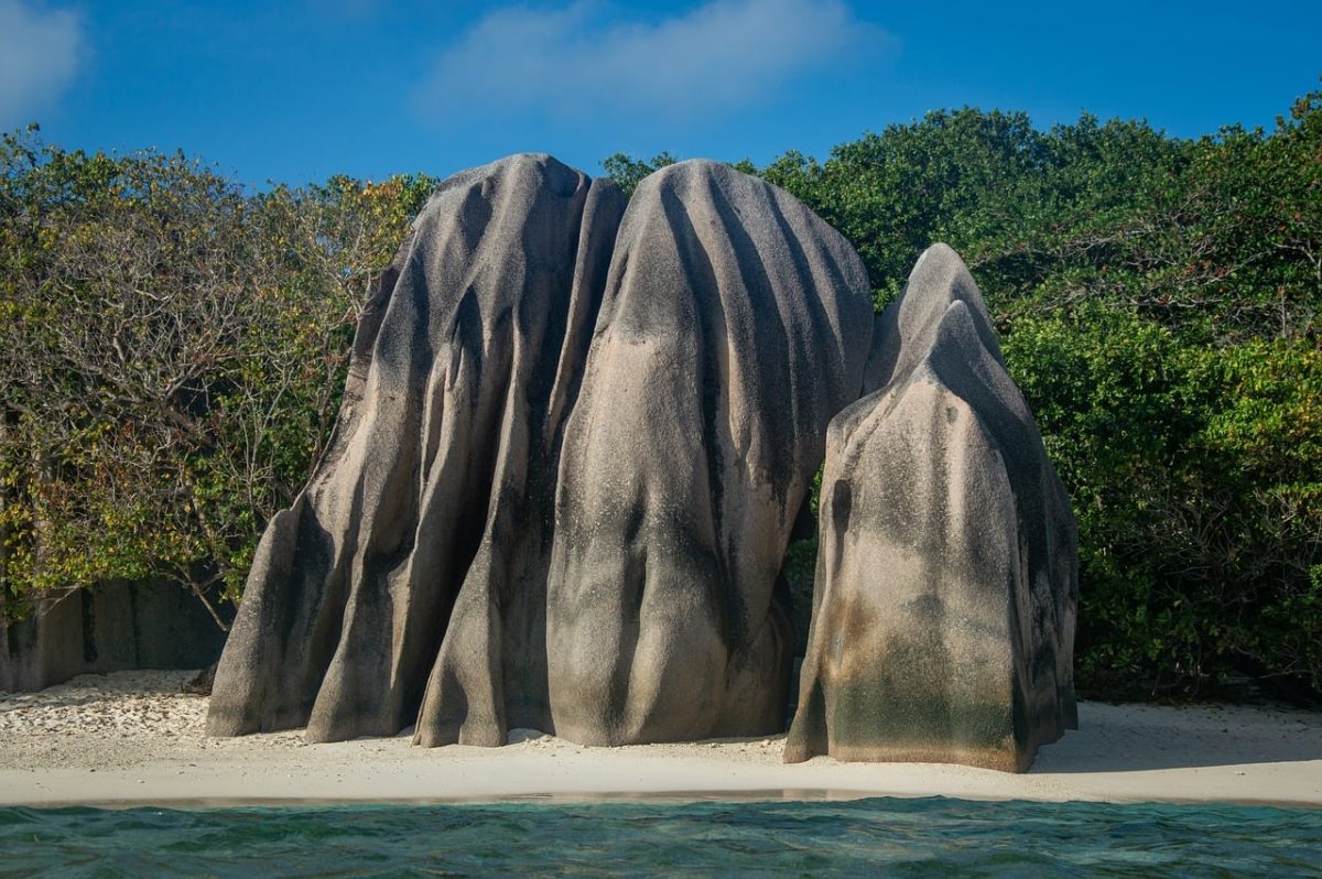 seychelles, beach, rocks, shore, crystal clear sea, tourism, natural beauty, giant boulders, tourist attraction, nature reserve, paths, sand, sunshine, relaxation, coastal location, vacation, blue sky, hidden beach, exotic, anibiz