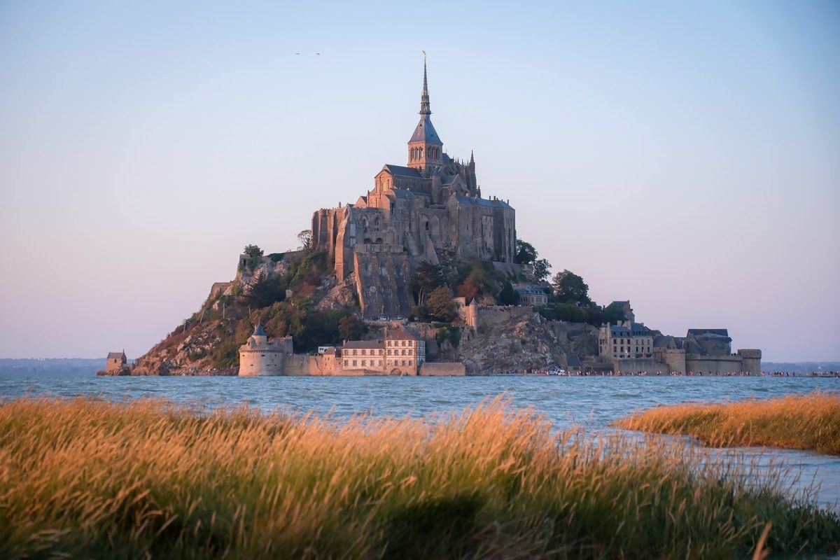 mont-saint-michel, historical architecture, medieval abbey, island, normandy, france, sunset, warm light, tourist attraction, coastal landscape, unesco world heritage, natural beauty, horizon, culture, romantic place, abstract, world heritage, medieval, tourism, landscape