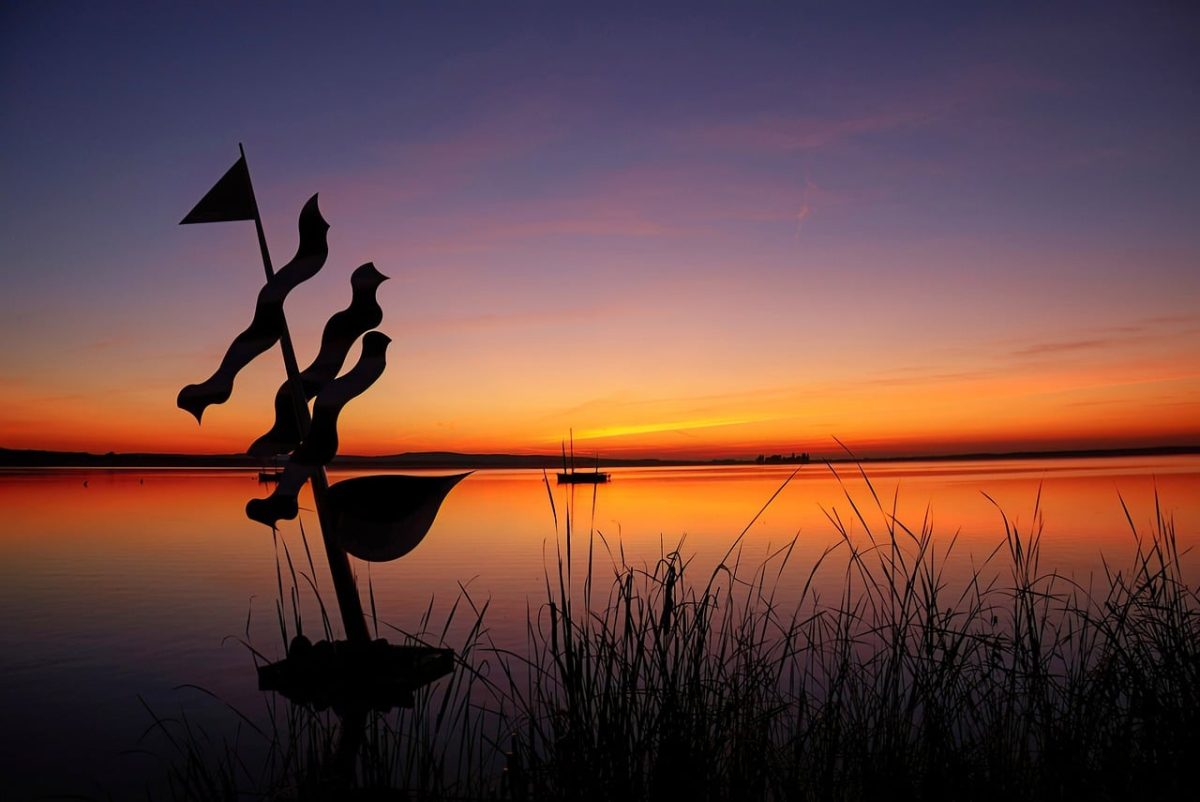 sunset, lake, reflection, evening calm, boat, water surface, ocean, silhouette, grass, art installation, orange sky, calm, nature, holiday, peaceful environment, relaxation, horizon, gentle, reeds, evening