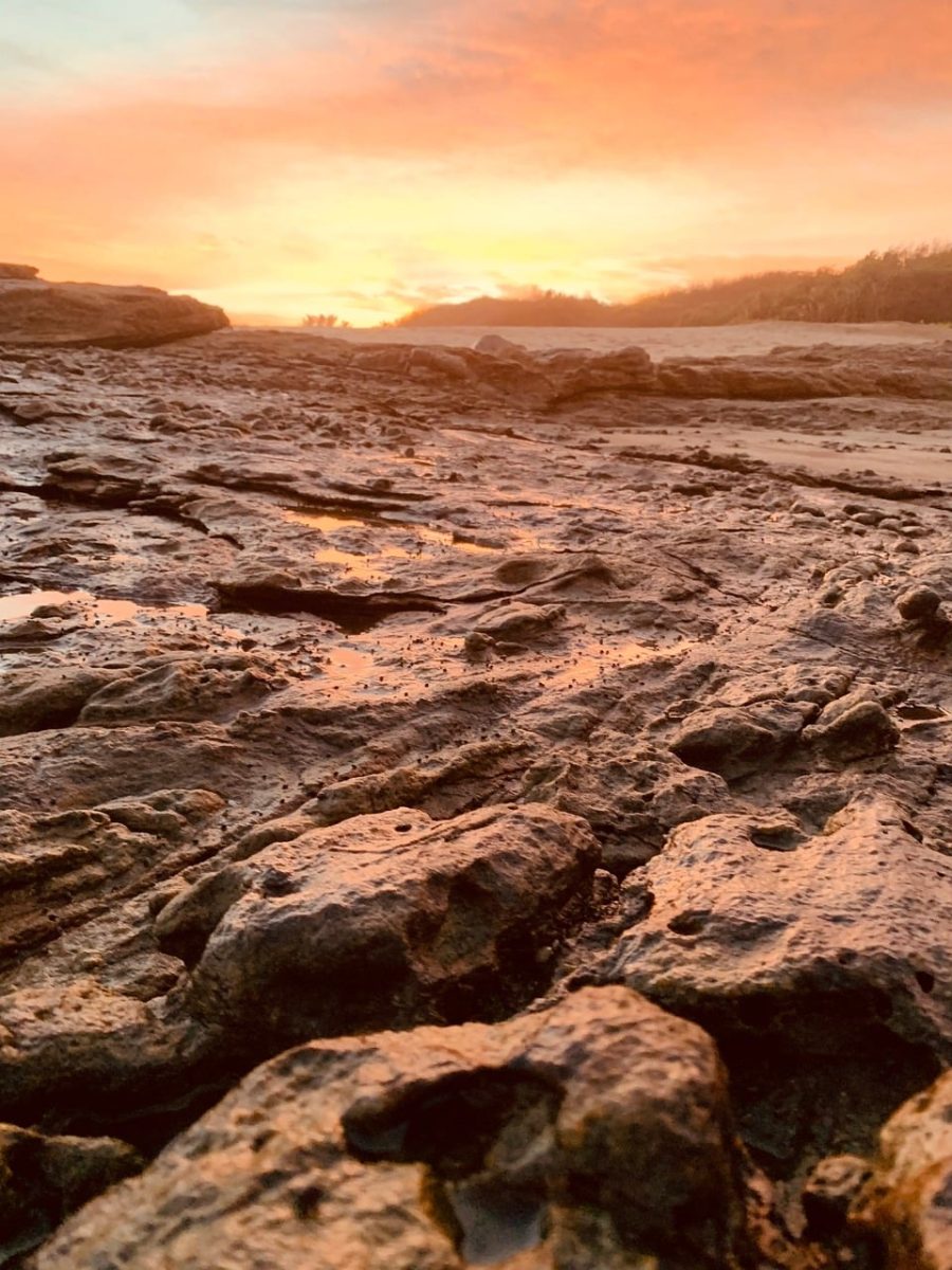 rocky beach, sunset, natural landscape, sky, wave, rock formation, seashore, sandy beach, landscape view, silhouette, golden hour, reflection, calm, nature, shelter, quiet, horizon, natural beauty, atmosphere, peace
