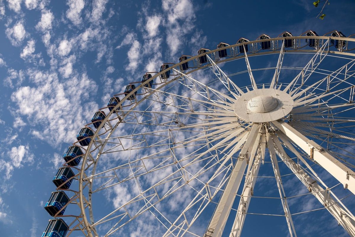 ferris wheel, blue sky, clouds, entertainment, fair, kids ride, amusement park, aerial view, festival, celebrations, nature, fun ride, carousel, sky, giant wheel, festive event, school trip, satisfaction, excitement, time of day, magic of the moment