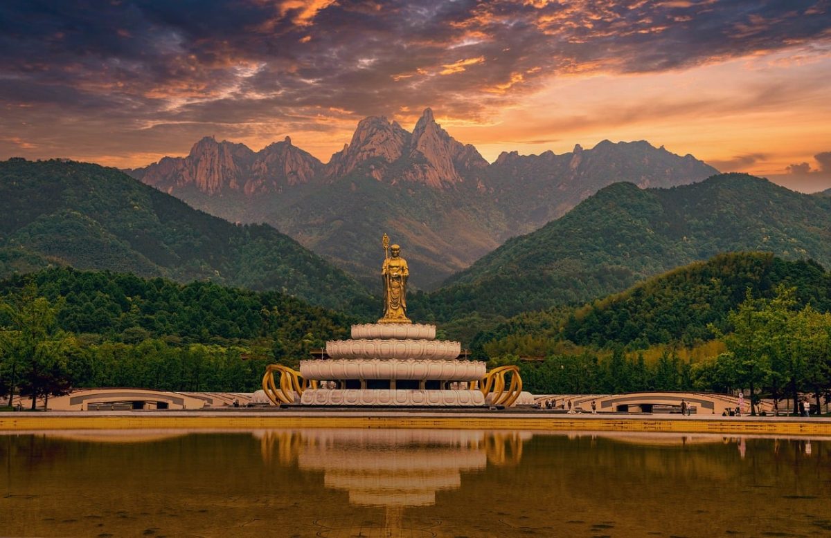 buddha statue, mountains, reflection, landmark, statue, culture, spirituality, peace, nature, sacred places, tourism, sunrise, eastern art, travel, calm, sights, zen, panoramic, religion, tranquility