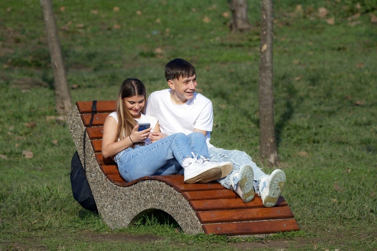 people, young, couple, happy, girl, boy, casual, smartphone, sitting, benches, park, nature, spring, relaxation, lifestyle