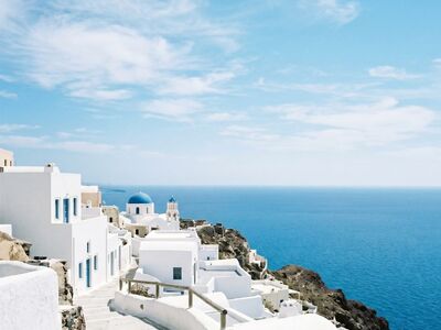 white houses, blue domes, ocean, coastal, travel, architecture, scenic, coastline, village, tourism, island, greece, cyclades, blue sky, aerial view, mediterranean sea, tourist attraction, white stucco, santorini, nature, seaside village