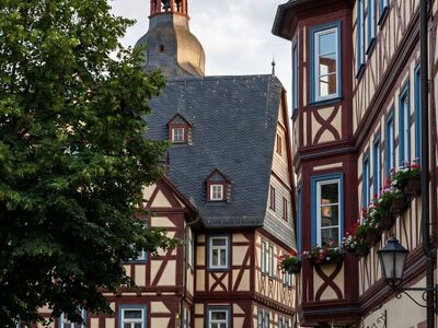 half-timbered house, historic architecture, cityscape, european village, church tower, traditional architecture, city street, romantic place, late afternoon, medieval style, flower boxes, wooden stucco, fresh flowers, window with flowers, red and white house, historic town, floral decoration, town center, pleasant afternoon, memorable place