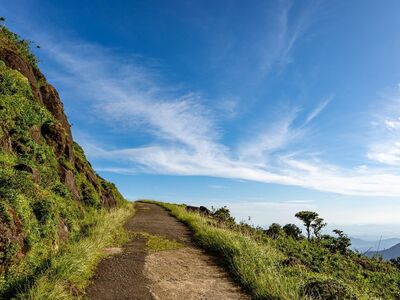 mountain path, blue sky, clouds, cliff, green vegetation, natural beauty, sunny day, mountains, hiking trail, nature, travel, excursion, relaxation, peaceful, vacation, sky, panorama, hiking, refuge, exterior, perspective