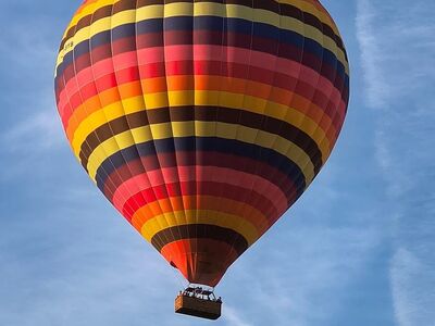 hot air balloon, blue sky, red, yellow, colorful stripe, adventure, mode of transport, travel, recreation, tourist attraction, cheerful, cloud haze, excursion, entertainment, high, lightness, climbing, view, balloon flight