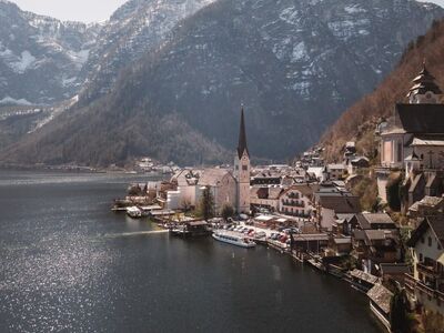 hallstatt, lake, mountain scenery, church tower, calm water, nature, alpine mountains, daylight, reflection, mountain view, peaceful scenery, lake and mountains, front view, cultural town, postcard, calm day, village atmosphere, architectural landmarks, blue sky, tourist destination
