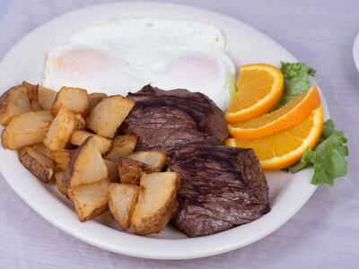 steak, eggs, home fries, american breakfast, orange slices, breakfast, brunch, grilled steak, beef, restaurant, diner, comfort food, homemade, cooked breakfast, protein, delicious, food photography, breakfast plate, fresh food
