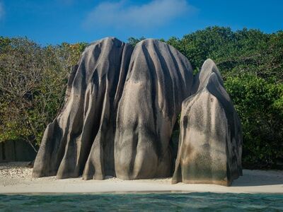 seychelles, beach, rocks, shore, crystal clear sea, tourism, natural beauty, giant boulders, tourist attraction, nature reserve, paths, sand, sunshine, relaxation, coastal location, vacation, blue sky, hidden beach, exotic, anibiz