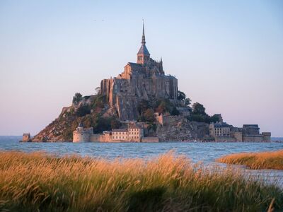 mont-saint-michel, historical architecture, medieval abbey, island, normandy, france, sunset, warm light, tourist attraction, coastal landscape, unesco world heritage, natural beauty, horizon, culture, romantic place, abstract, world heritage, medieval, tourism, landscape