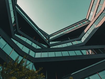 modern architecture, urban view, architectural design, multi-angular building, long angle view, blue sky, office building, modern city, abstract architecture, minimalist aesthetics, skyscraper, light reflection, urban architecture, geometric patterns, window facade, urban environment, building structure, outdoor view, building construction, modern offices