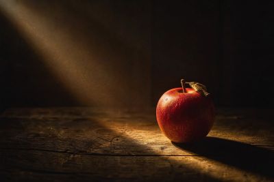 still life, apple, red, dark wood, beam of light, shadow, fine detail, warm atmosphere, texture, reflection, nature, waxed detail, golden, composition, charming, original, stippling, leaf, autumn, quiet, unique perspective