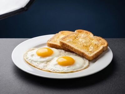 fried eggs, sunny side up, breakfast, toast, buttered toast, fried bread, yolk, white plate, white porcelain, slate table, blue background, studio lighting, delicious, meal, food, morning, gourmet, culinary, appetizing, simple