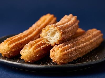 churro, fried dough, sweet, dessert, cinnamon sugar, crispy, golden brown, plate, slate table, blue background, studio shot, delicious, treat, spanish food, traditional, sweet tooth, edible, delicacy, tidbit, split, hollow