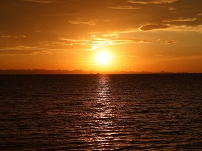 sunset, ocean, sea, horizon, golden hour, sun, water, golden light, mountains, orange sky, nature, landscape, reflection, tranquil, calm, dusk, twilight, evening, sea wave