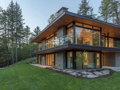 modern architecture, glass terrace, family home, forest, nature, outdoor setting, luxury property, garden, lawn, wooden structure, residential property, wide verandah, evening lighting, contemporary design, sunlight, forest landscape, relaxation area, panoramic view, evening sky, open living room, concrete flooring, trees in background