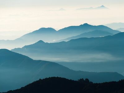 nepal, annapurna circuit, poon hill trek, dawn, morning mist, sea of clouds, layered mountains, blue tone, mountain silhouette, himalayan peaks, fog valley, alpine landscape, trekking, mountain panorama, atmospheric haze, landscape photography, sunrise preview, mountain layers