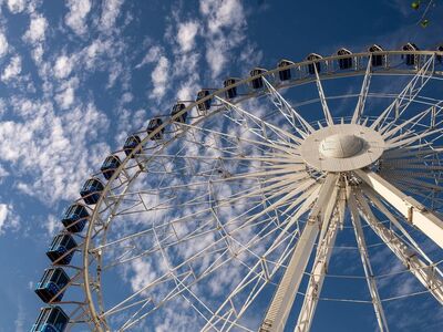 ferris wheel, blue sky, clouds, entertainment, fair, kids ride, amusement park, aerial view, festival, celebrations, nature, fun ride, carousel, sky, giant wheel, festive event, school trip, satisfaction, excitement, time of day, magic of the moment