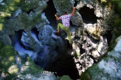 man, casual, climbing, stones, cliffs, cave, cavern, moss, sunny, shadows, composition, alpinism, sport, adrenaline, danger