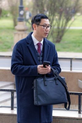 man, asiatic, eyeglasses, casual, overcoat, bag, smartphone, standing, outdoors, street, subway entrance, lifestyle