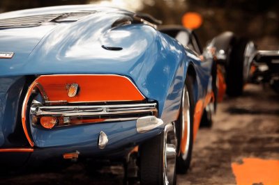 sports car, luxury car, classic car, retro design, blue car, convertible, exhaust, wheels, antique, collector car, taillights, expensive, rubber tires, paint, vintage, brand, asphalt road, outdoors, city, focus on car