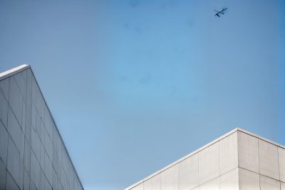 architecture, minimalistic, building corners, airplane in sky, blue sky, abstract, simplicity, modern design, outdoor, urban, creative composition, space, soothing, light and shadow, geometry, clear sky, building outlines, media content, abstract art, sky photography