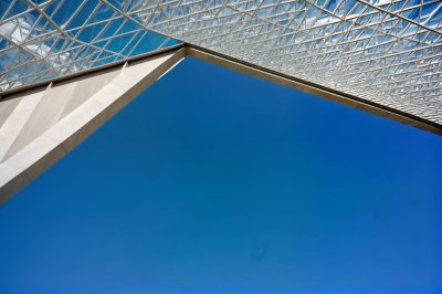 modern architecture, blue sky, geometric shape, perspective angle, minimalism, concrete building, architectural detail, shadow variation, morning light, clear day, outdoor setting, straight lines, linear composition, stylish design, architectural perspective, no detail, building angle, shadowed, sunny day