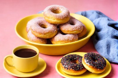 donuts, chocolate sprinkles, yellow dishes, sweet treat, breakfast, pastry, cup of coffee, snack, indonesian pastry, coffee beverage, powdered sugar, cake, serving platter, baking, homemade, blue fabric, fresh, dessert